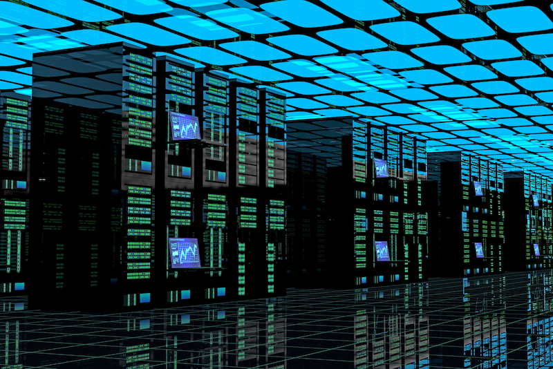 Data center with rows of computers with lights and monitors